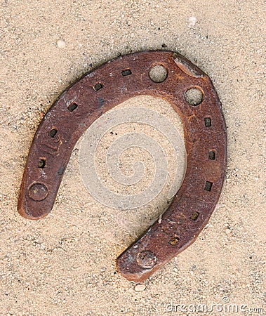 Old rusty horseshoes on sand Stock Photo