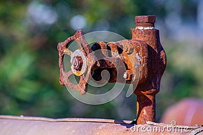 old and rusty industrial liquid control faucet. Stock Photo