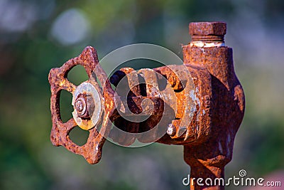 old and rusty industrial liquid control faucet. Stock Photo