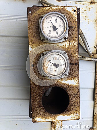 Old rusty industrial thermometers on a sunny day Stock Photo