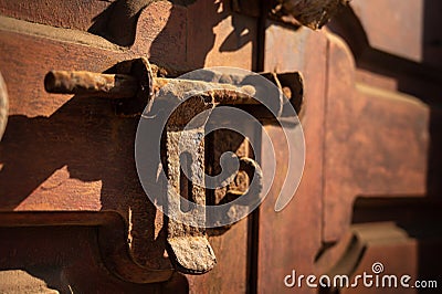 Old rusty iron latch on a wooden door Stock Photo