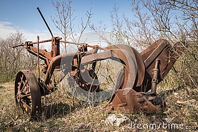 Old rusty iron plow abandoned. Stock Photo