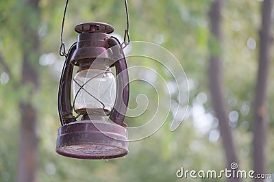 Old and rusty kerosene lantern have bokeh as background Stock Photo