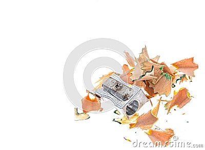 Old rusty metal pencil sharpener and different colour shavings. Stock Photo