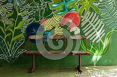 old rusty metal seats on art painting wall Stock Photo