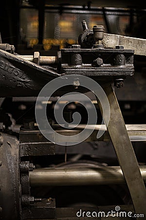 Old iron parts on the rods and driving wheels of a steam engine Stock Photo