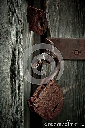 Old rusty opened lock without key. Vintage wooden door, close up concept photo Stock Photo