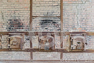 old rusty oven door surrounded by bricks Stock Photo