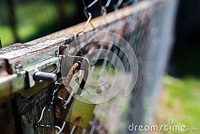 Old rusty padlock on wired garden fence , shallow depth of field Stock Photo