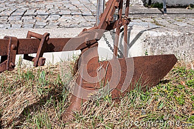 An old rusty ploughshare in a garden Stock Photo