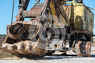 an old rusty quarry excavator is located on the territory of a mining quarry. an open method of mining Stock Photo