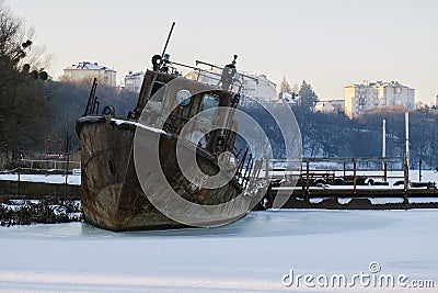 Old rusty rescue boat froze in the ice Stock Photo