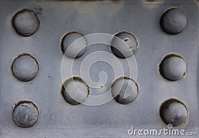 Old rusty rivets on large corroding steel plates of a train and Stock Photo