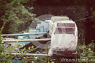 Old rusty roller coaster in an abandoned park with a hot summer Stock Photo