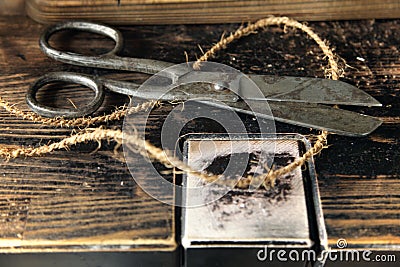 Old rusty scissors on the wooden table Stock Photo