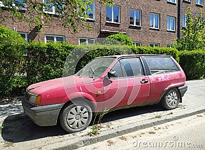 Old rusty scrap wrecked abandoned car red compact Volkswagen Polo Editorial Stock Photo