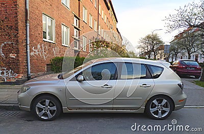 Old rusty silver Mazxda 3 first version four doors parked Editorial Stock Photo