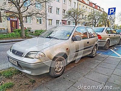 Old rusty silver Suzuki Swift two doors parked Editorial Stock Photo