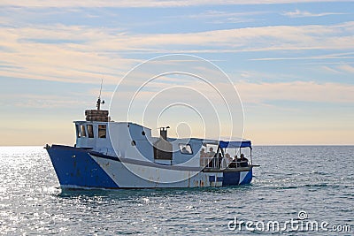 An old rusty small boat is carrying people Editorial Stock Photo