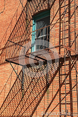 Old,rusty staircase on outside of brick building Stock Photo