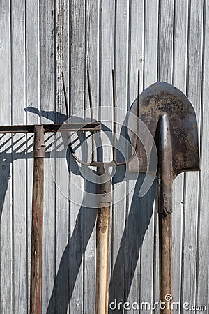 The old rusty tools, implements or household equipment on wooden background. Stock Photo