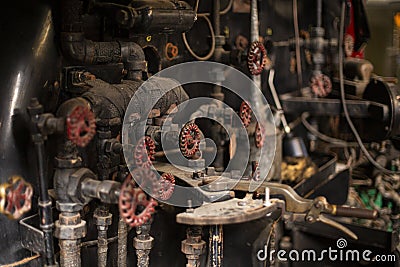 Old rusty valves, pipes, and gauges on an antique steam engine Stock Photo