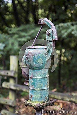 Old rusty water pump in the forest Stock Photo