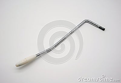 Old rusty whammy bar for electric guitar on white Stock Photo