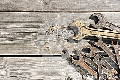 Old rusty wrenches on a wooden table Stock Photo