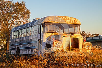 Old school bus in field Stock Photo