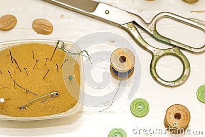 Old scissors, needles and wooden spools Stock Photo