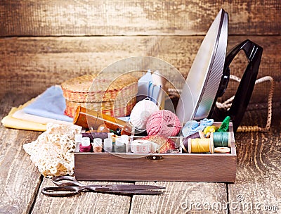 Old scissors, various threads, iron and sewing tools Stock Photo