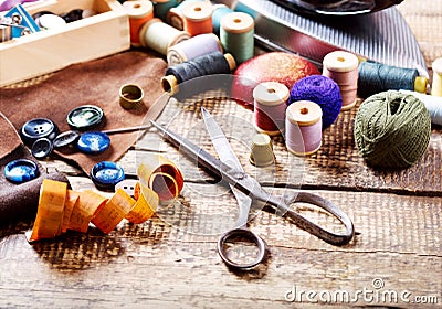 Old scissors, various threads and sewing tools Stock Photo