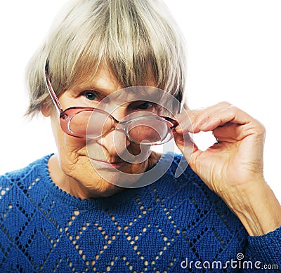 Old senior lady looking through her eyeglasses Stock Photo