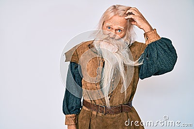 Old senior man with grey hair and long beard wearing viking traditional costume worried and stressed about a problem with hand on Stock Photo