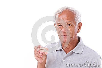 Old senior man with hand holding denture Stock Photo