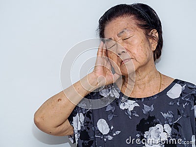 Old senior woman suffering and covering face with hands in headache and deep depression. emotional disorder, grief and desperation Stock Photo