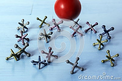 Jacks on Blue Table and Red Rubber Ball Stock Photo