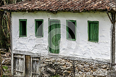 Old settler house in green landscape Stock Photo