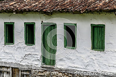 Old settler house in green landscape Stock Photo