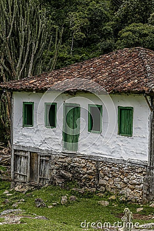 Old settler house in green landscape Stock Photo