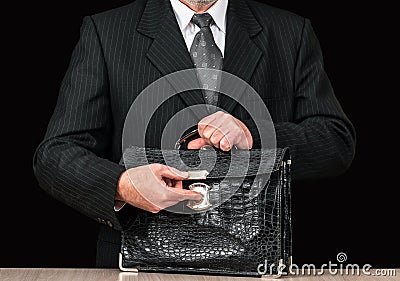 Old shabby leather briefcase in businessmans hand Stock Photo