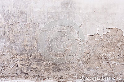 Old shabby wall with flaky plaster and a lot of cracks Stock Photo