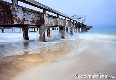 Old ship pier and sea wave in storming season Stock Photo