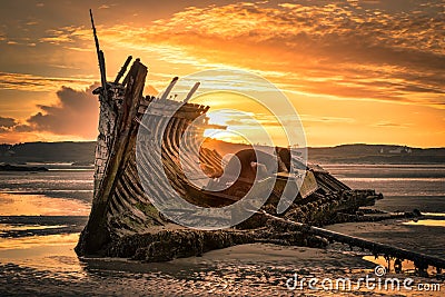 Old Ship Wreck at Sunset Stock Photo