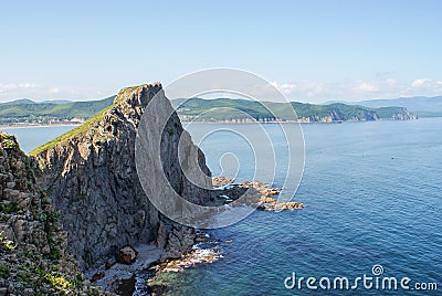 An old shipwrecked ship stands on the shore at the foot of a rocky cliff. Cape Briner. Primorsky Krai. Russia Stock Photo