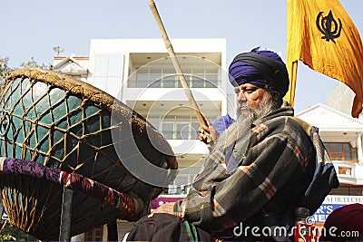 An old sikh gentleman beating a huge drum Nagara Editorial Stock Photo
