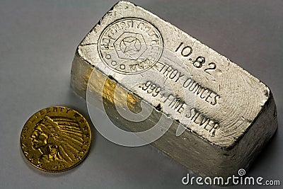 Old Silver Bullion Bar and Gold Coin Stock Photo