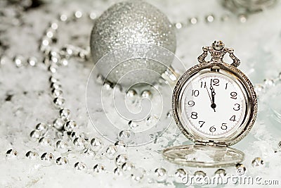 Old silver clock close to midnight and Christmas decorations Stock Photo