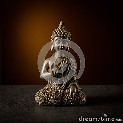 Old silver color statuette Buddha sitting in yoga pose Stock Photo